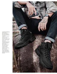 Detail of high-top hiking boots with reinforced toe and non-slip rubber soles on rocks