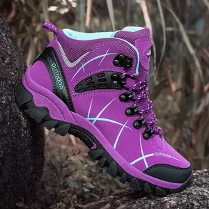Purple high-top hiking boots with non-slip rubber soles on rocky outdoor terrain