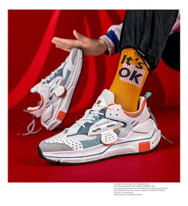 Detail der Leder-Patchwork-Chunky-Sneaker mit orangefarbenen Akzenten und Netzgewebe