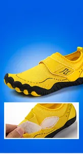 Detail of vibrant yellow water shoe with adjustable velcro strap for easy wearing