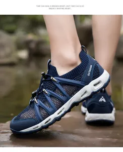 Macro detail of breathable navy mesh outdoor wading shoes with drainage holes on sole