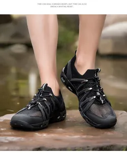 Close-up of black breathable mesh water shoes with quick-lace system for outdoor wading