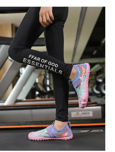 Detail of kids quick-dry water shoes with non-slip pink rubber sole on treadmill