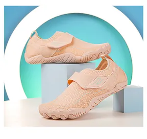 Detail view of pink breathable mesh water shoes with non-slip sole and hook-and-loop strap