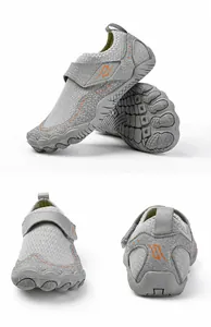 Detail view of grey breathable water shoes with anti-slip rubber soles and velcro straps