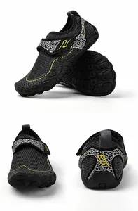 Detail view of black anti-slip water shoes for kids with velcro and rubber soles