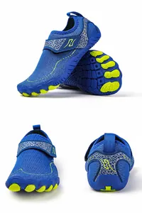 Detail view of non-slip rubber sole and velcro strap on blue water shoes for kids