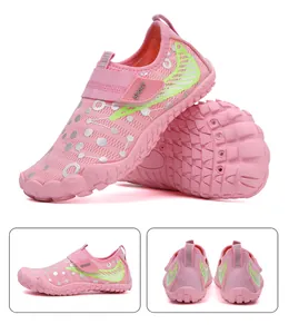 Macro detail of kids water shoes with pink non-slip rubber sole and velcro sport strap