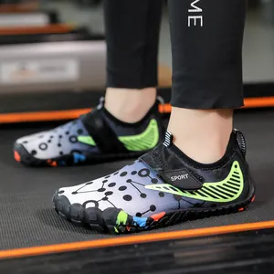 Kids quick-dry water shoes with black gradient pattern and green stripes on a treadmill