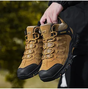 Close-up of khaki outdoor hiking boots featuring non-slip rubber soles and suede texture