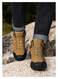 Close-up of khaki suede hiking boots with reinforced black toe caps and rugged outdoor soles