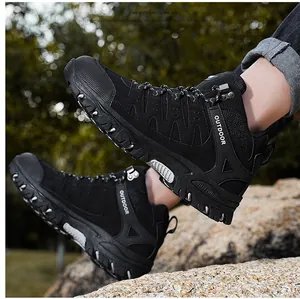 Close-up of black hiking boots with sturdy metal eyelets and rugged non-slip rubber soles