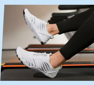 White minimalist barefoot fitness shoe with quick-lace system on gym treadmill