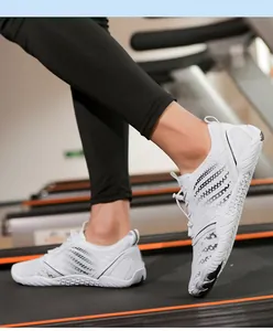 Detail of white breathable water shoes for gym and running on a treadmill surface