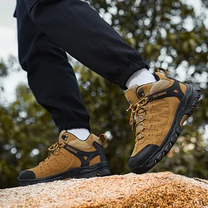 Men's high-top hiking boots in brown leather with non-slip rubber soles on rocks
