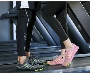 Detail of outdoor hiking shoes with breathable mesh and quick-lace system on treadmill