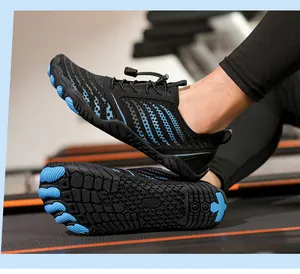 Detail of non-slip rubber sole and breathable mesh on black and blue aqua shoes