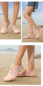 Detail of pink aqua shoes showing the quick-lace system and blue wave patterns on sand