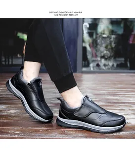 Detail showing plush lining of black outdoor walking shoes for men on wood deck