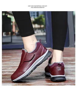 Detail of burgundy non-slip walking shoes with warm gray fur lining and velcro strap