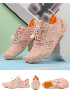 Detail view of orange quick-dry water shoes with breathable mesh and wave pattern