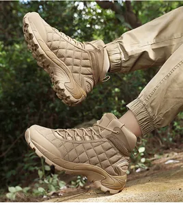 Side view of khaki tactical hiking boots with non-slip soles in outdoor forest setting