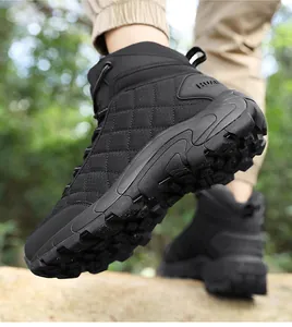 Macro shot of high-top hiking boots with non-slip rubber soles on outdoor rocks