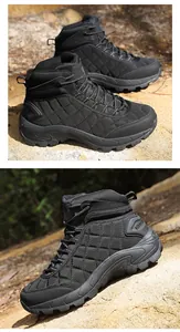 Detail of durable black outdoor hiking boots with rugged anti-slip soles on rocks