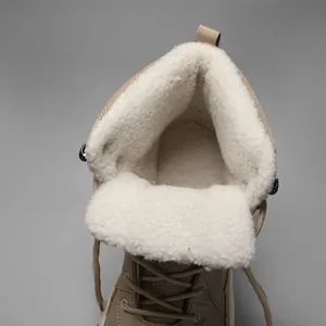 Detail view of thickened faux lamb wool lining and warm suede upper of winter boots