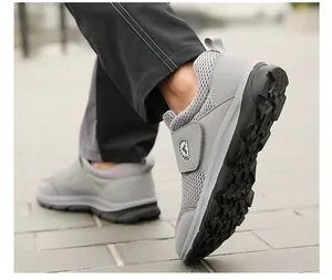 Detailed close-up of breathable grey mesh sneakers with velcro strap and anti-slip rubber sole