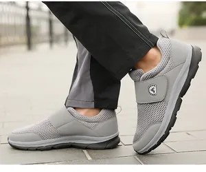 Detail of grey mesh walking shoes featuring adjustable hook and loop closure and soft sole
