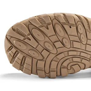 Close-up of khaki rubber sole with deep anti-slip tread pattern for outdoor tactical boots