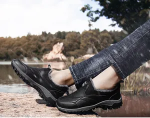 Close-up of men's winter boots featuring warm grey plush lining and durable leather exterior