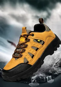 Detail of waterproof hiking boots with leather upper and anti-collision toe in a splash setting