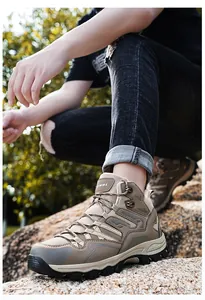 Macro view of khaki hiking boots with metal lace eyelets and rugged outdoor sole