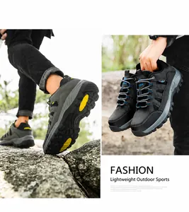 Detail of high-top hiking shoes with yellow anti-slip rubber outsoles and synthetic leather