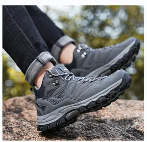 Macro view of hiking boots with anti-slip rubber soles standing on natural rocks