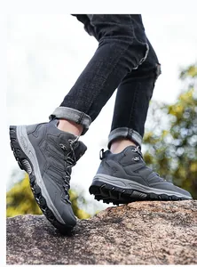 Macro shot of dark gray hiking boots with metal lace eyelets and rugged rubber sole