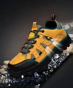 Close-up of khaki trekking boots featuring breathable mesh and durable leather texture