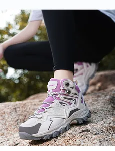 Close-up of the beige outdoor hiking boot featuring purple mesh and durable rubber sole