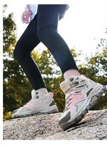 Detailed side view of high-top hiking boots featuring durable rubber soles and mesh fabric