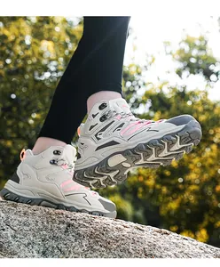 Outdoor hiking boot with thick rubber sole and multi-color patchwork on rugged rocks