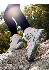 Detailed view of women's hiking boots with pink accents and deep lug anti-slip soles