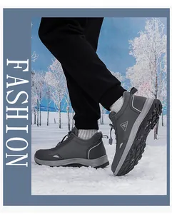 Close-up of waterproof hiking shoes on snow featuring durable soles and warm lining