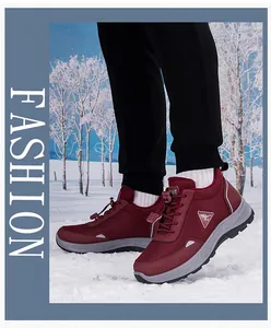 Burgundy waterproof hiking shoes on snow with non-slip thick soles and bungee laces