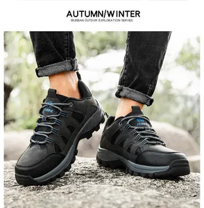 Close-up of hiking boots with black nubuck and mesh on a rocky outdoor terrain