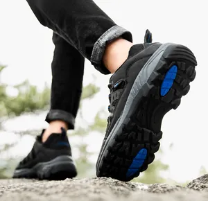 Low angle view of durable hiking boots with deep tread rubber soles for outdoor climbing