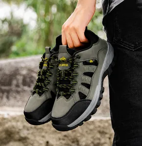 Close-up of olive green hiking boots with rugged anti-slip soles in outdoor nature setting