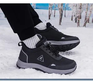 Detail of waterproof hiking shoes with quick-lace system in a winter snow landscape