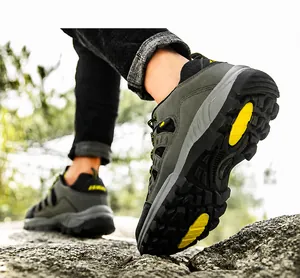 Close-up of gray hiking shoes with anti-slip rubber soles in natural forest scenery